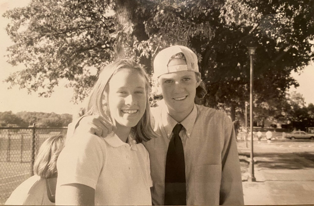 A male and a female high school friends smiling in a black & white photo from the late 1990's